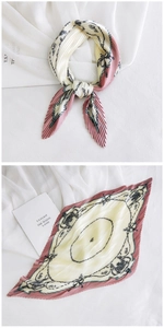 Detail of pleated silk scarf with vintage chain print in dusty pink and cream colors
