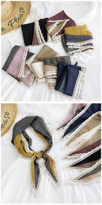 Close-up of color-block cotton linen scarves with delicate lace trim and vintage tones