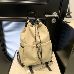 Waterproof nylon drawstring backpack in beige with contrast black dual front pockets