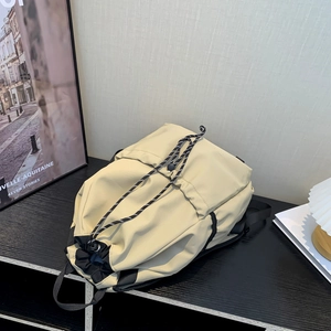 Minimalist beige waterproof nylon drawstring backpack with sporty black contrast straps