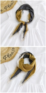 Detail of grey and yellow linen scarf with white lace trim and contrast stitching