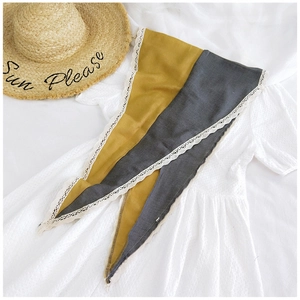 Detail of color-block cotton linen scarf with elegant white lace embroidery edges