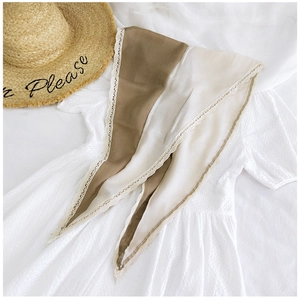 Close-up of diamond pattern cotton linen scarf with lace edges and bicolor design