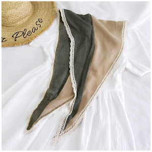 Detail of rhombic color-block cotton linen scarf with elegant beige lace trim