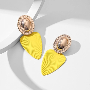 Détail de boucles d'oreilles feuilles tendance avec métal texturé et pendentifs feuilles jaunes