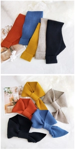 Detailed view of knitted cross scarf showing soft ribbed texture and vibrant color options