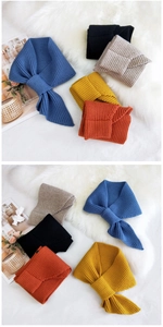 Detail of solid color knitted neck warmer showing ribbed texture and cross-slit design