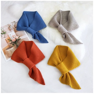 Vertical rib-knit texture detail of soft knitted cross scarves in multiple colors
