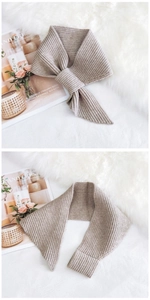Macro detail of beige ribbed knit scarf showing texture and elegant bow knot styling