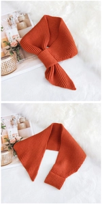 Detail of burnt orange ribbed knit scarf showing texture and cross-over slit design