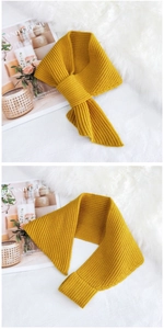 Detailed knit texture of ginger yellow winter scarf with vertical stripe pattern
