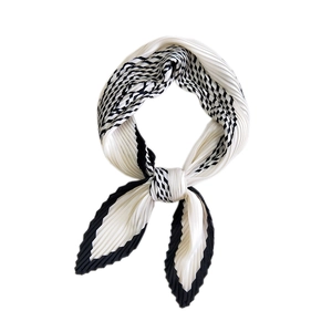 Checkerboard pleated silk scarf in black and white with elegant accordion fold design