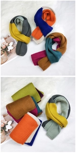 Detail of multi-color knitted scarf texture showing premium stitch work and soft wool yarn