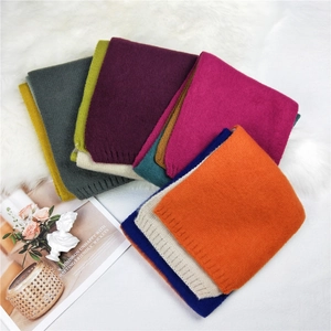 Chic multi-color knitted scarf collection with ribbed edges on a soft plush background