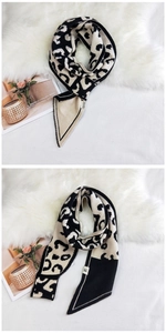 Detail of leopard print knitted scarf with triangle ends and brand label on plush background