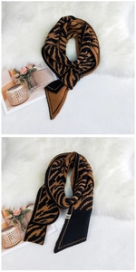 Detail of tiger pattern knit scarf showing soft texture and sharp diagonal edge design