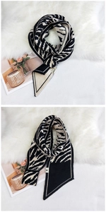 Close-up of zebra pattern knitted scarf texture with decorative horse embroidery detail
