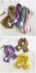 Detail of soft teddy plush scarf with cross-wrap design and Hutton brand label