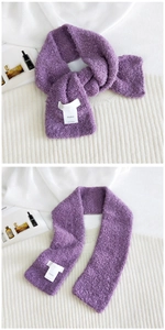 Detailed view of purple knit scarf with fluffy loop yarn texture and Hutton label