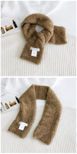 Detailed close-up of brown plush teddy fleece scarf with stitched Hutton brand label