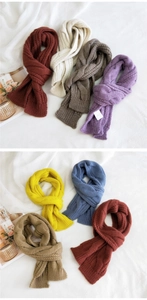 Detail showing cable knit textures on multiple colorful winter scarves in various shades