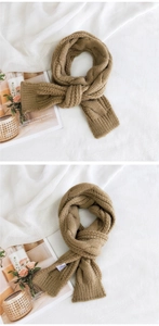 Close-up of khaki cable knit scarf texture with ribbed hem and stylish layering