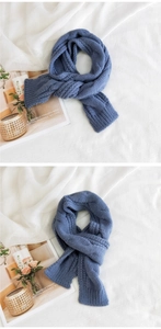Detail of navy blue knitted scarf with thick cable texture and warm winter fabric