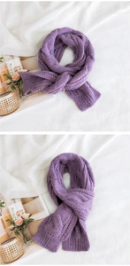 Detail of purple chunky cable-knit scarf with thick ribbed edges and fluffy texture