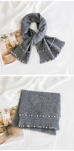 Detailed close-up of grey knitted scarf with pearl accents and vertical rib texture
