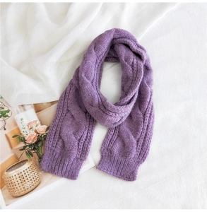 Macro shot of purple cable-knit pattern and soft texture on solid winter scarf