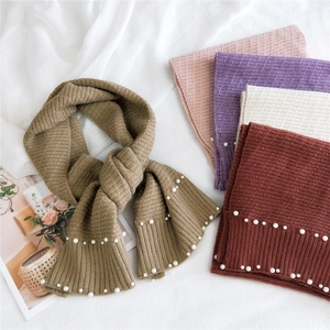 Knitted scarves with pearls in beige, pink, and burgundy on soft ribbed fabric
