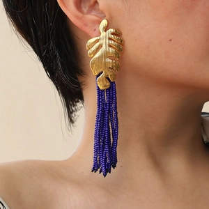 Bohemian gold leaf earrings with long purple beaded tassels for a tropical vacation look