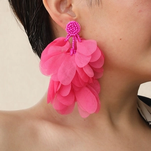 Close-up of hot pink tiered chiffon petal earrings with intricate beaded top detail