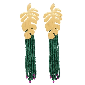 Detailed shot of bohemian leaf earrings with green bead tassels and gold metal finish