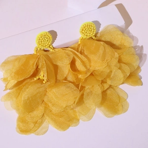 Detail of yellow tulle petal earrings with handmade beaded studs for summer