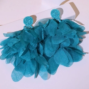 Detail of blue petal tassel earrings with handcrafted beads and layered organza fabric
