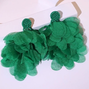 Detail of emerald green handmade oversized floral earrings with bead embroidery and organza layers