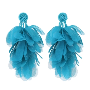 Close-up of bohemian blue fabric petal tassel earrings with beaded round base details