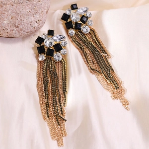 Detail of long tassel earrings with black rhinestones and multi-tone metal chains