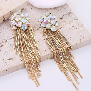 Macro shot of long gold crystal tassel earrings with sparkling rhinestones details