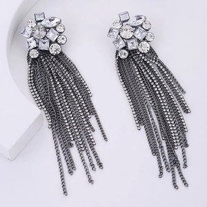 Macro detail of silver tassel earrings featuring marquise and square cut rhinestones