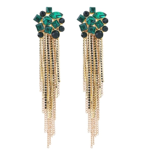 Detailed view of emerald green and black crystal clusters with long gold chain tassels