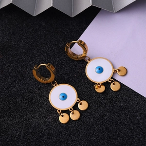 Detailed close-up of gold titanium steel evil eye earrings with bohemian dangling sequins