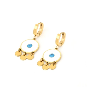 Detail of gold evil eye drop earrings featuring blue charms and polished tassels