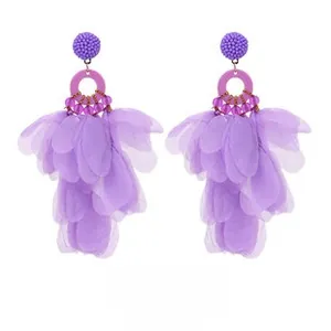 Close-up of purple fabric flower tassel earrings with intricate beadwork and tulle petals