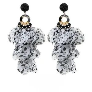 Detail of bohemian drop earrings with leopard petals and black velvet spheres