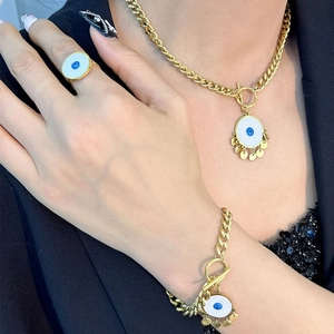Gold Evil Eye jewelry set with chunky chain necklace, bracelet and ring on a model