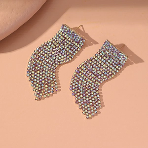 Macro shot of long tassel drop earrings with sparkling rhinestones and gold base