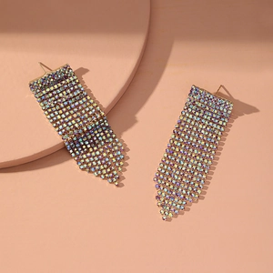 Detail of long tassel earrings with iridescent AB rhinestones on a gold setting