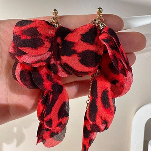 Close-up of handmade leopard print fabric petal tassel earrings with gold studs